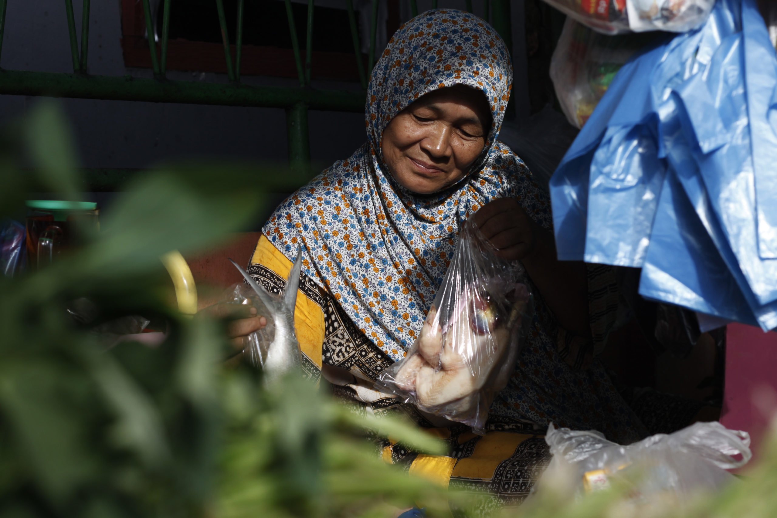 A woman is arranging her groceries.